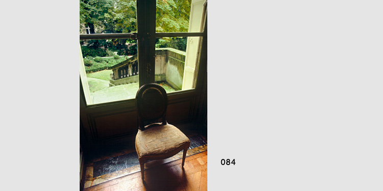 Photograph of chair in front of window in paris